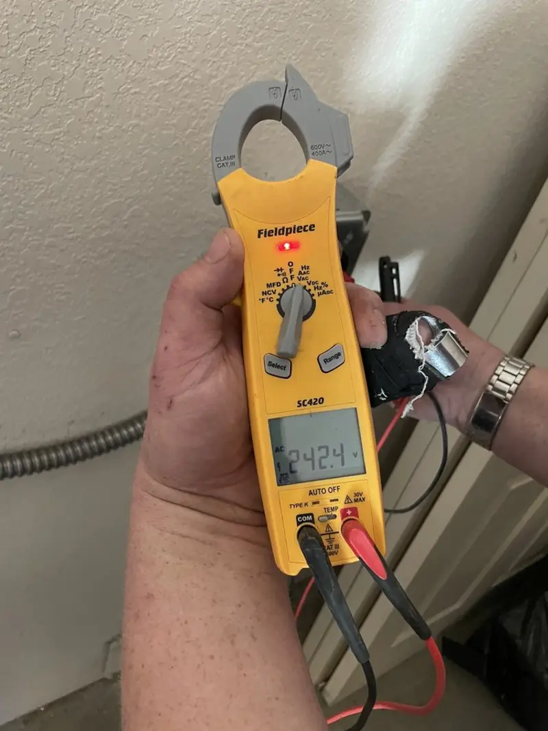 Voltage testing with clamp meter during Ceiling Fan Installation in Newport Beach
